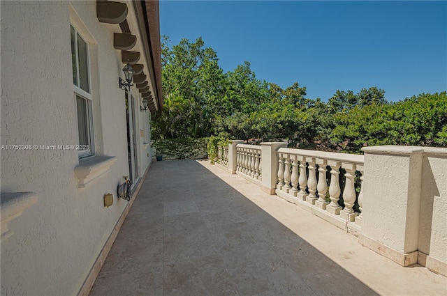 view of patio featuring a balcony