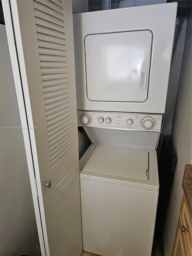 clothes washing area featuring laundry area and stacked washer and dryer