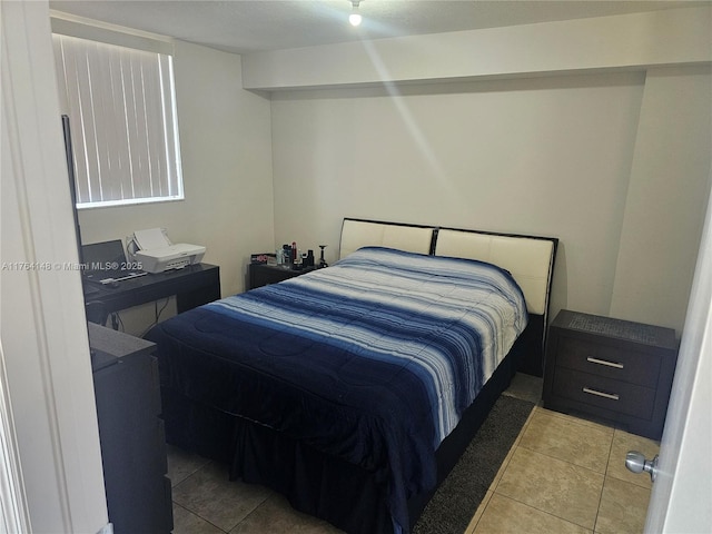 bedroom with light tile patterned floors