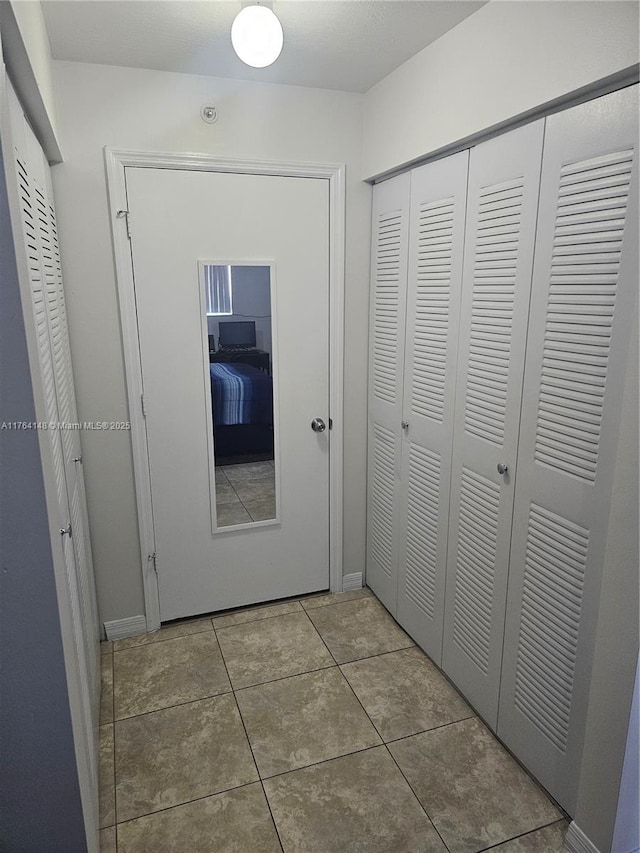 hall with tile patterned flooring