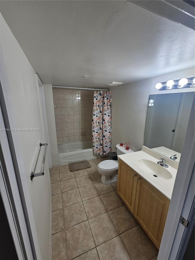 full bathroom featuring vanity, tile patterned flooring, shower / tub combo, a textured ceiling, and toilet