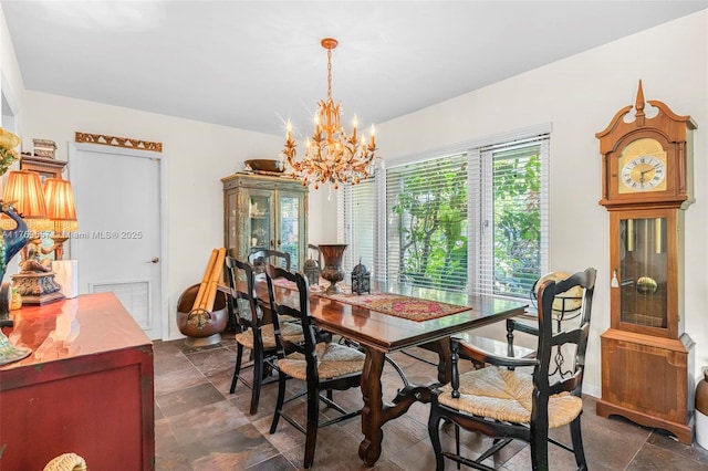 dining room with an inviting chandelier, visible vents, and stone finish flooring