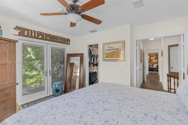 bedroom with a walk in closet, access to exterior, a ceiling fan, and visible vents