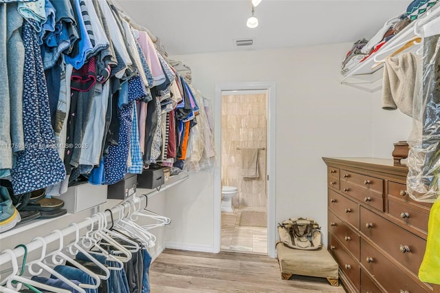 walk in closet with visible vents and light wood-type flooring