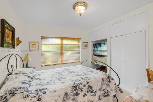 bedroom featuring a closet and light carpet