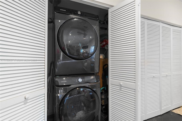 washroom with stacked washer / dryer and laundry area