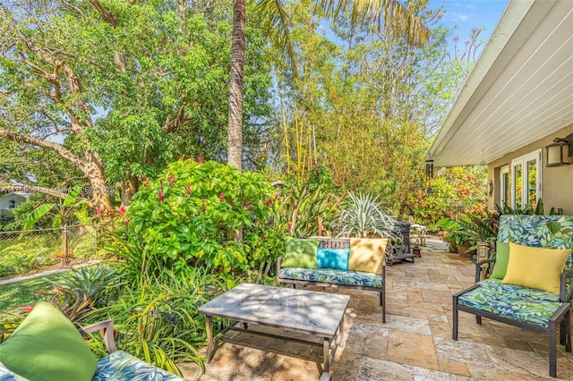 view of patio / terrace featuring an outdoor living space and fence