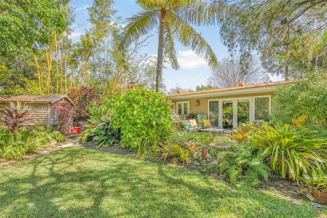 view of yard with french doors and a patio