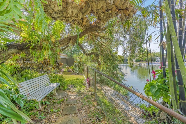 exterior space with fence and a water view