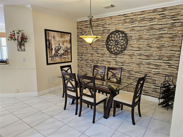 dining space with visible vents, crown molding, and baseboards