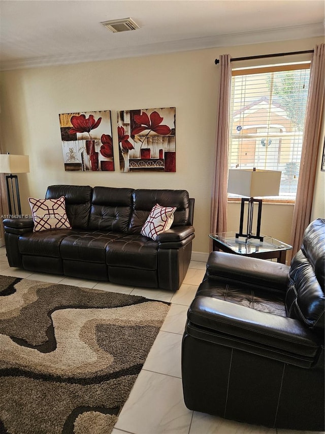 living area featuring visible vents and ornamental molding