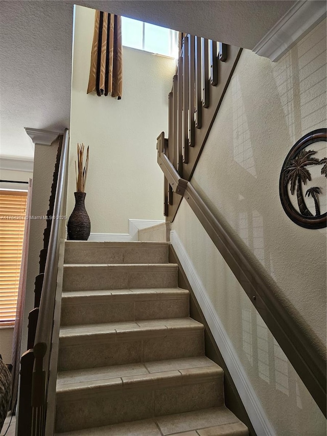 stairs with a textured ceiling