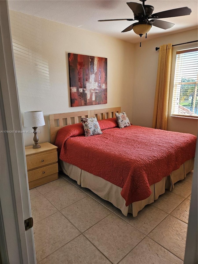 bedroom with light tile patterned flooring and a ceiling fan