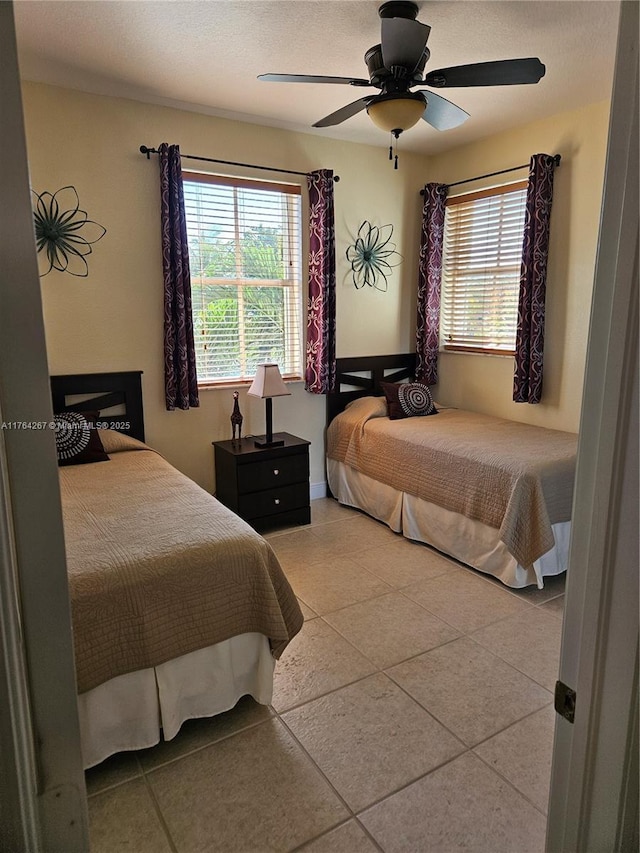 bedroom featuring tile patterned flooring and ceiling fan