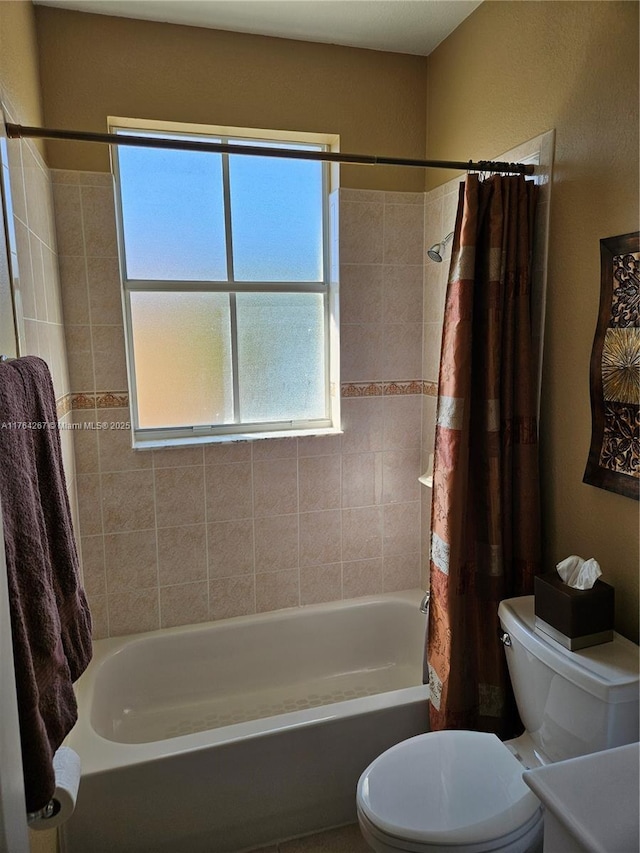 full bath with toilet and shower / bath combo with shower curtain