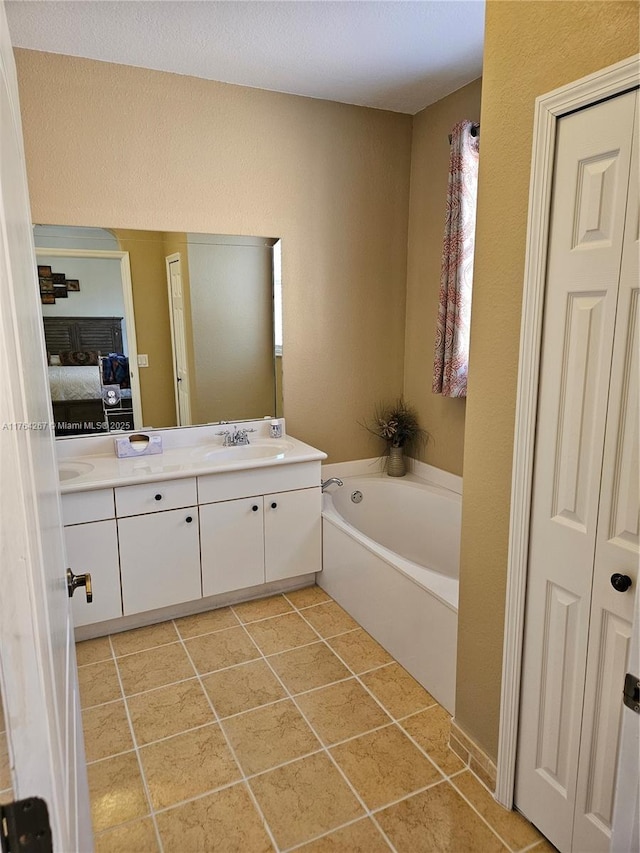 bathroom featuring vanity, tile patterned floors, a bath, and connected bathroom