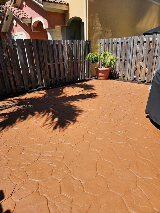 view of patio / terrace featuring fence