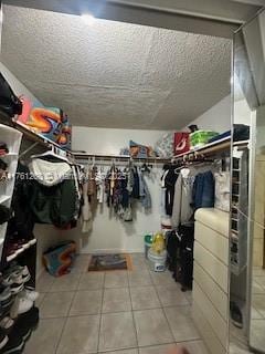 walk in closet with tile patterned floors