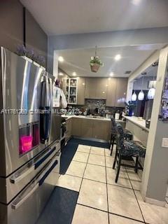 kitchen with light tile patterned floors and stainless steel fridge with ice dispenser