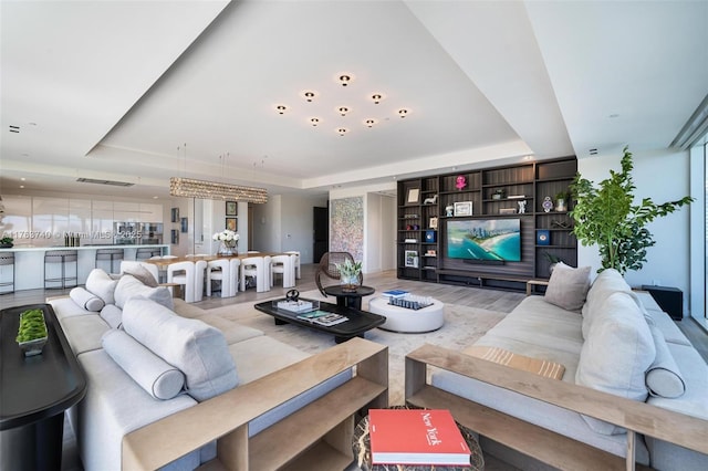 4701 N Meridian Ave Unit 603, Miami Beach, FL 33140 - living room featuring a tray ceiling and light wood-style floors