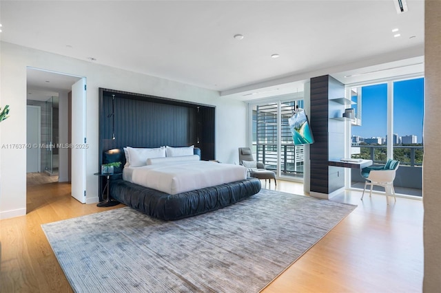 4701 N Meridian Ave Unit 603, Miami Beach, FL 33140 - bedroom featuring visible vents, a city view, wood finished floors, baseboards, and access to exterior