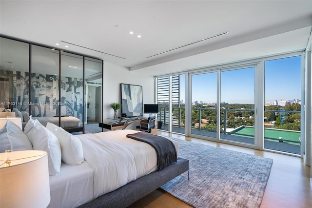 4701 N Meridian Ave Unit 603, Miami Beach, FL 33140 - bedroom featuring recessed lighting, wood finished floors, a wall of windows, and access to outside