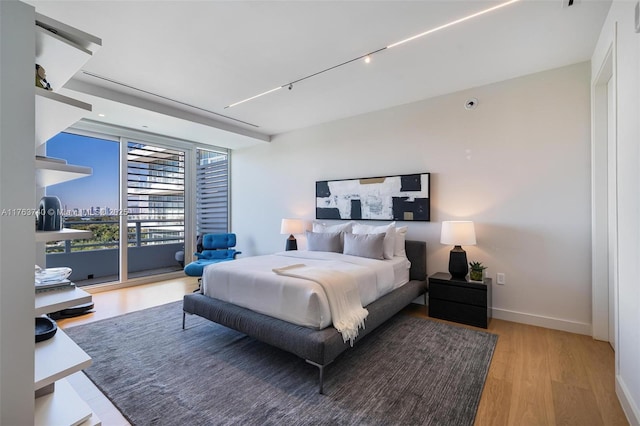4701 N Meridian Ave Unit 603, Miami Beach, FL 33140 - bedroom with baseboards, wood finished floors, and access to exterior