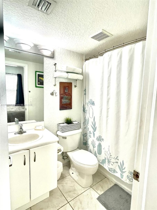 7326 Collins Ave Unit 207, Miami Beach, FL 33141 - full bathroom with vanity, toilet, tile patterned flooring, a shower with curtain, and a textured ceiling