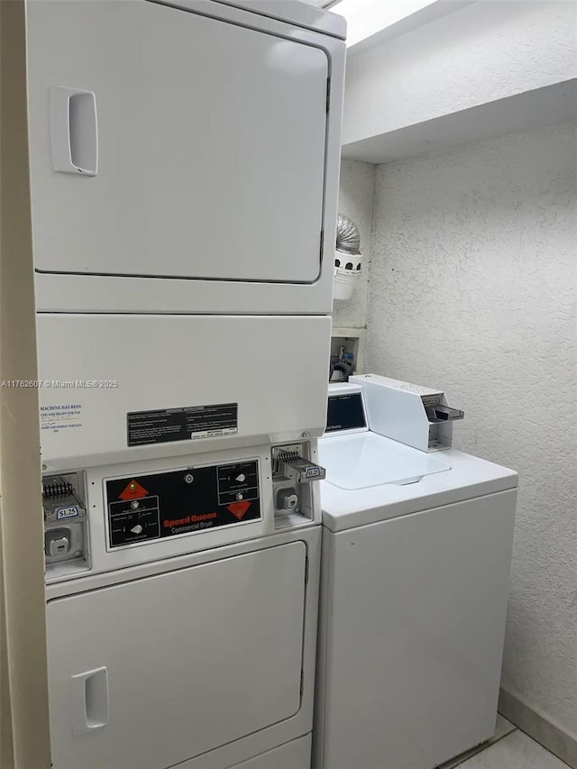 7326 Collins Ave Unit 207, Miami Beach, FL 33141 - communal laundry room with a textured wall, stacked washer / dryer, and washing machine and dryer