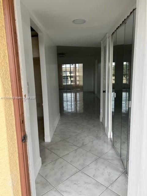 hall featuring light tile patterned floors