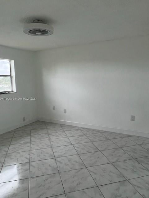 empty room featuring baseboards