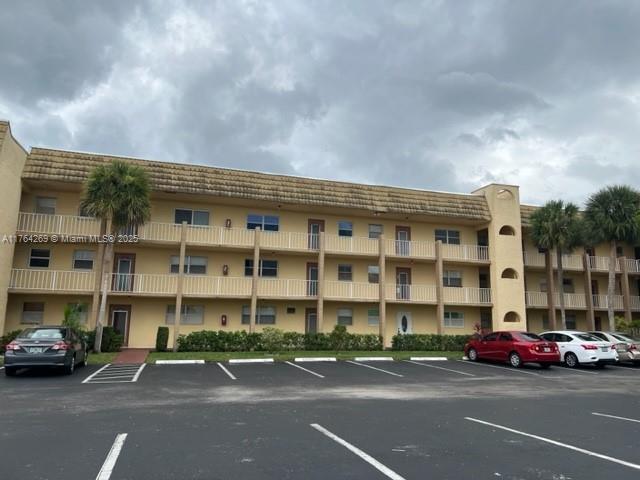 view of building exterior featuring uncovered parking