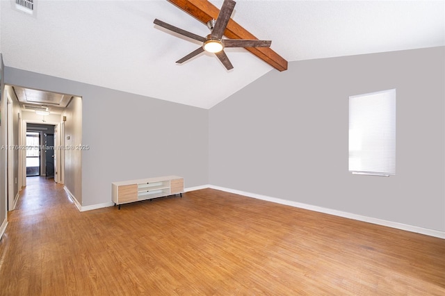 spare room featuring a ceiling fan, visible vents, baseboards, attic access, and light wood-style flooring