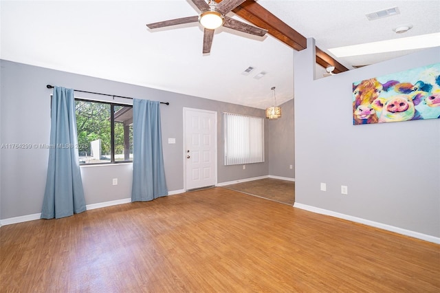 spare room featuring visible vents, baseboards, lofted ceiling with beams, ceiling fan with notable chandelier, and light wood-type flooring