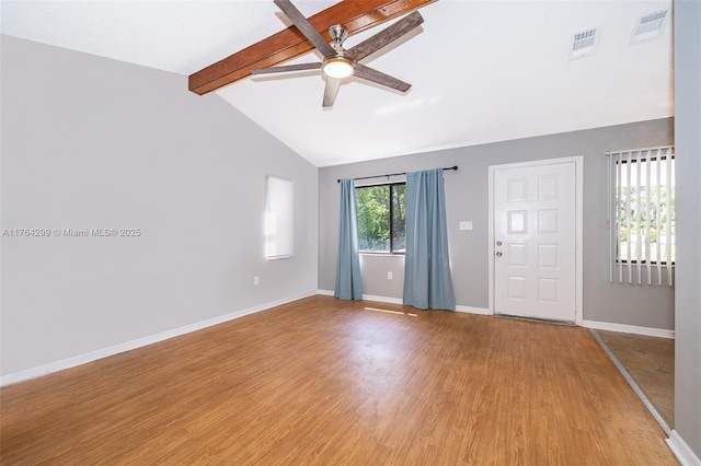 spare room with light wood-type flooring, visible vents, vaulted ceiling with beams, and ceiling fan