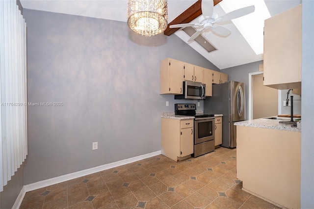 kitchen with baseboards, a sink, stainless steel appliances, lofted ceiling with skylight, and ceiling fan with notable chandelier