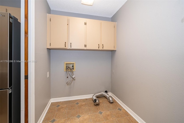 washroom with hookup for a washing machine, baseboards, cabinet space, tile patterned flooring, and a textured ceiling