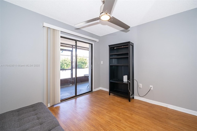 unfurnished room with ceiling fan, baseboards, and light wood-style flooring