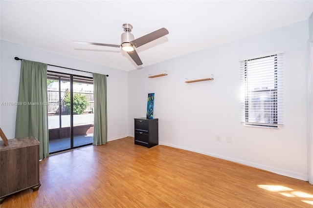 empty room with ceiling fan, baseboards, and light wood-style flooring