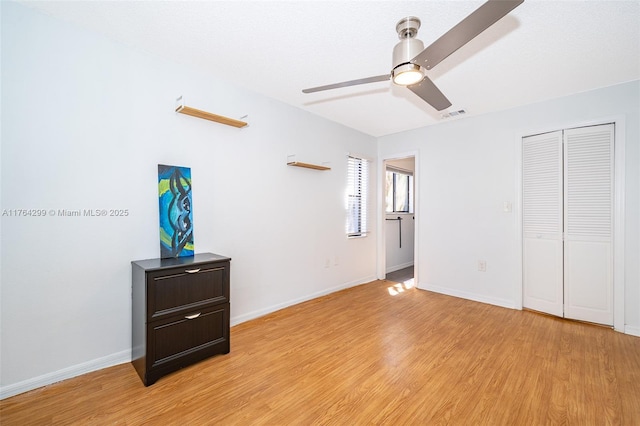 bedroom featuring visible vents, baseboards, a closet, and light wood-style flooring