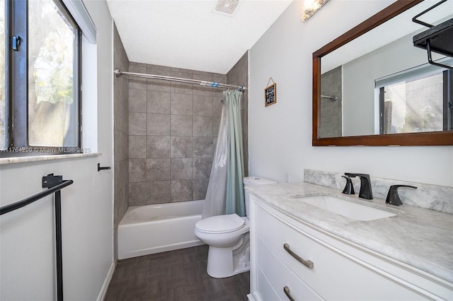 bathroom featuring a wealth of natural light, vanity, toilet, and shower / tub combo with curtain