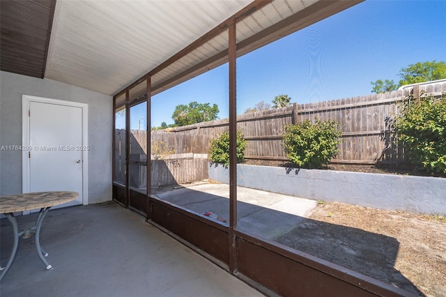 unfurnished sunroom with lofted ceiling