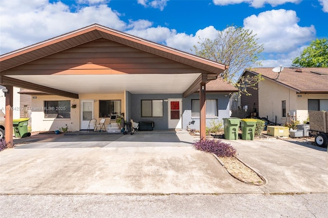 view of front of property featuring stucco siding and a carport