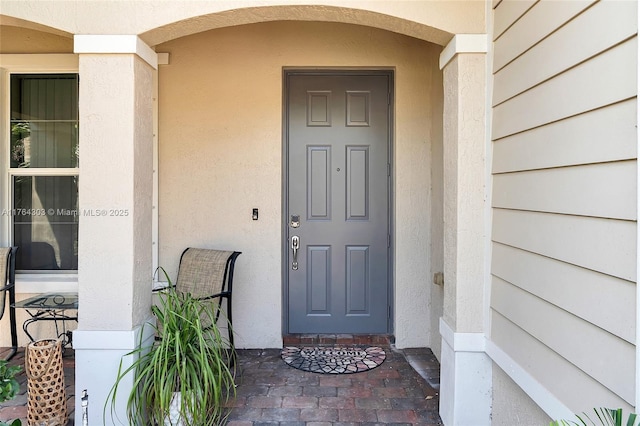 84 Belle Grove Ln, Royal Palm Beach, FL 33411 - doorway to property with stucco siding and a porch