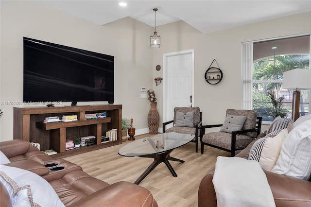 living area featuring light wood-style flooring and baseboards