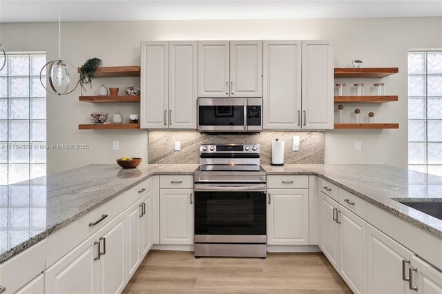 84 Belle Grove Ln, Royal Palm Beach, FL 33411 - kitchen featuring stainless steel appliances, open shelves, tasteful backsplash, and white cabinets