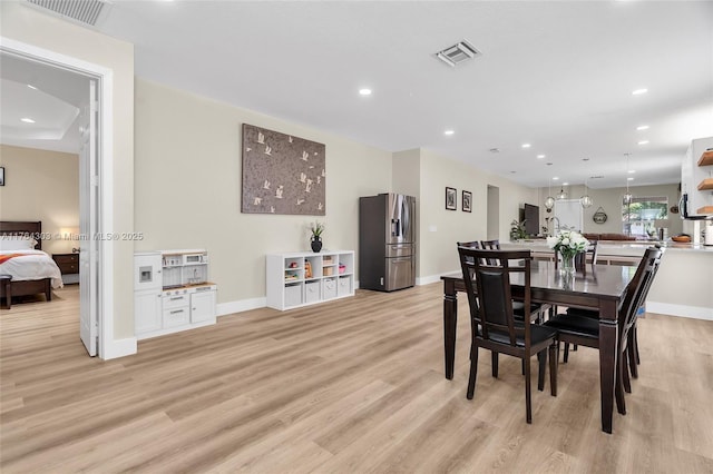 dining room featuring recessed lighting, visible vents, and light wood-type flooring