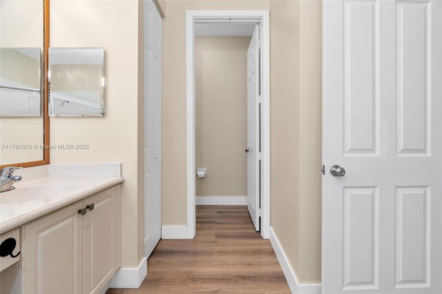 84 Belle Grove Ln, Royal Palm Beach, FL 33411 - bathroom with vanity, wood finished floors, and baseboards