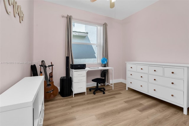 office featuring ceiling fan, baseboards, and light wood-style flooring