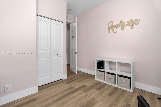84 Belle Grove Ln, Royal Palm Beach, FL 33411 - unfurnished bedroom with baseboards, wood finished floors, and a closet